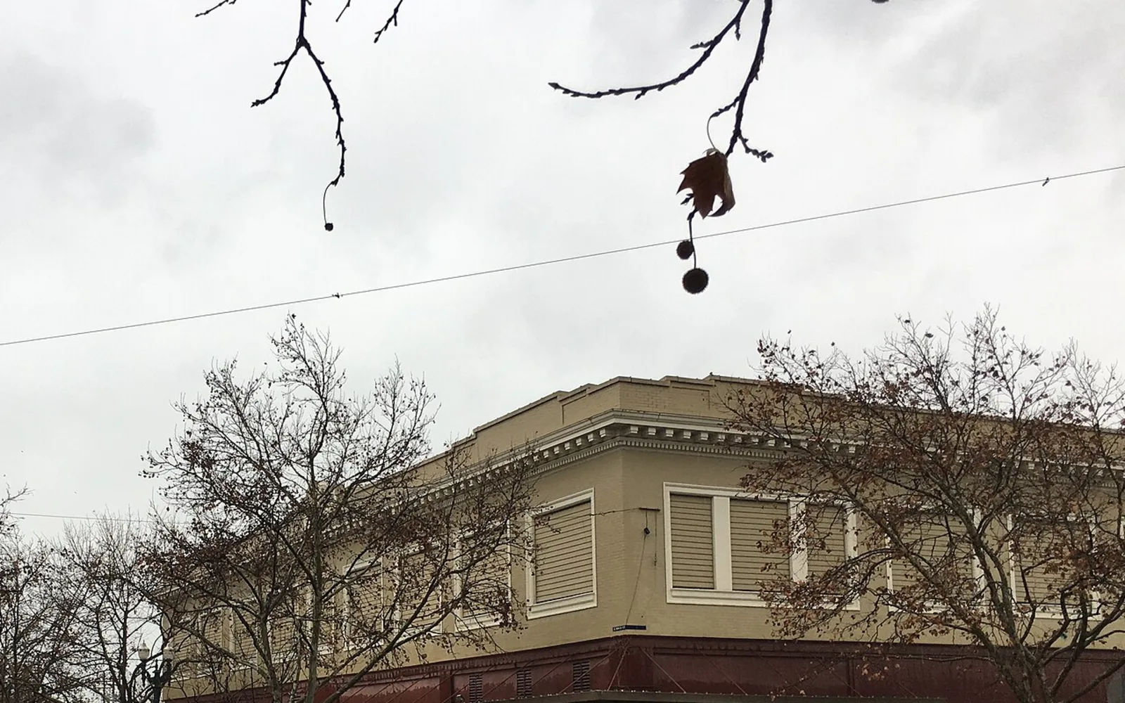 Upper storefront facades in historic downtown Turlock on a rainy day.